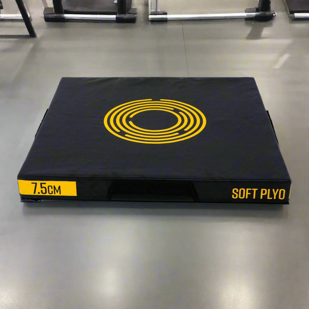 Jordan Fitness 3-inch Soft Plyo Box - Black and Yellow, In a gym setting. Made of high-density foam blocks covered in non-slip vinyl