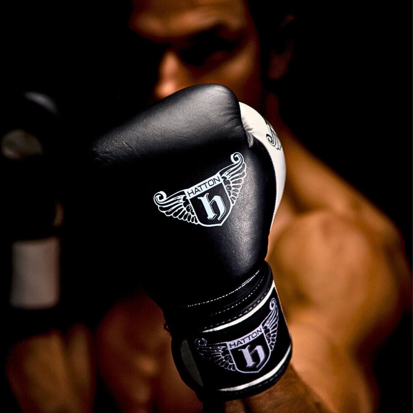 A boxing with the Hatton Pro Sparring Leather Velcro Gloves in black and white