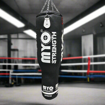 Myo Strength Punch Bag - Angle 4ft - Leather - Heavy-Duty in black and white in a gym setting