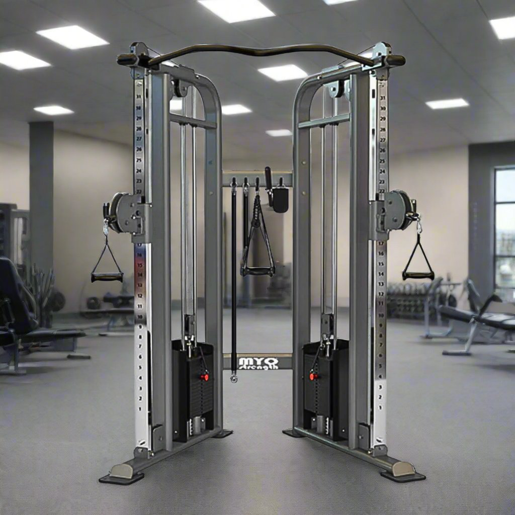 Myo Strength Dual Adjustable Pulley Cable Machine. The silver and black frames, along with high-quality upholstery, give these machines a sleek and stylish appearance. With x2 80kg weight stacks, easy adjustments, and durable features such as non-absorbing PVC grips, in a gym setting