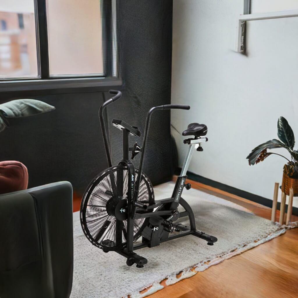 The Air Attack Bike in black in a living room space showing it is easy to move and convenient to use at home